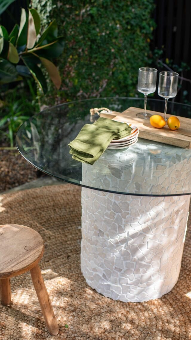 Outdoor stone-base table with glass top