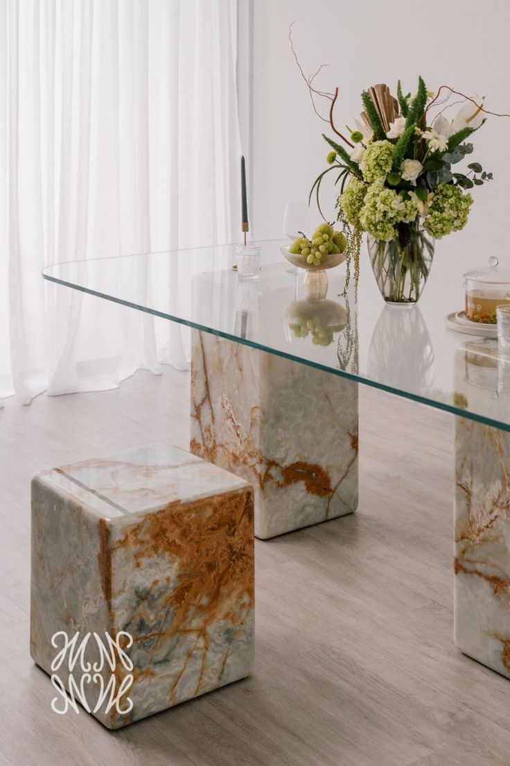 Glass dining table on onyx stone pedestals